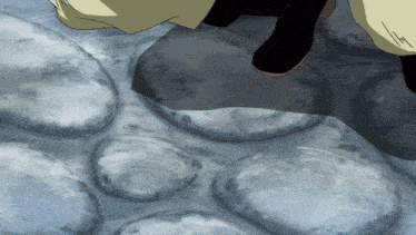 a close up of a person 's feet standing on a rocky surface