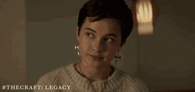 a young woman wearing a sweater and earrings with the craft legacy written on the bottom
