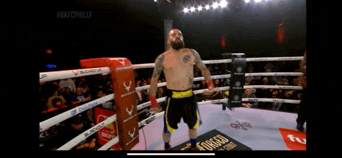 a man in a boxing ring with a sign that says forced