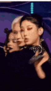 a group of women are standing next to each other on a stage holding a microphone .