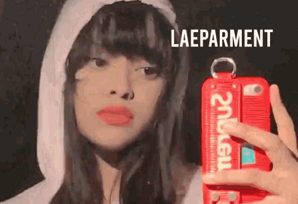 a woman taking a selfie with a supreme case