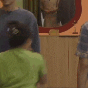 a group of people are standing in a room .