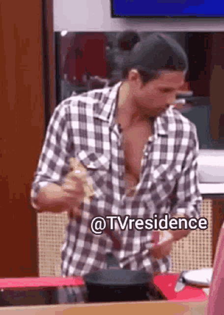a man in a plaid shirt is stirring something in a pan with the words @tvresidence below him