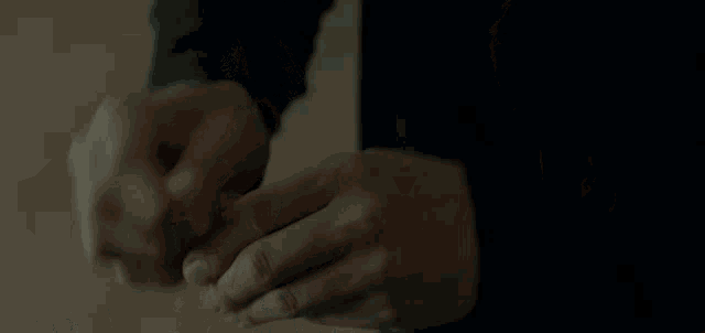 a close up of a person holding something in their hands