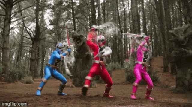 a group of power rangers are fighting a monster in the woods .