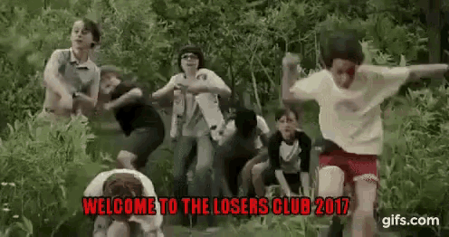 a group of children are jumping in the air in a field .