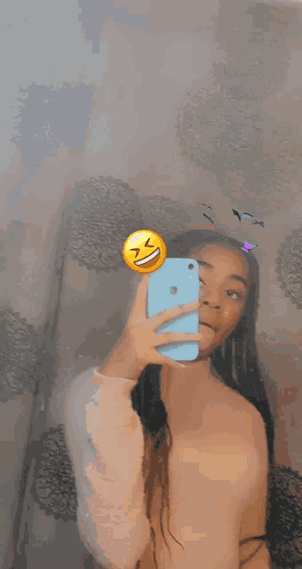 a girl is taking a picture of herself with an apple phone