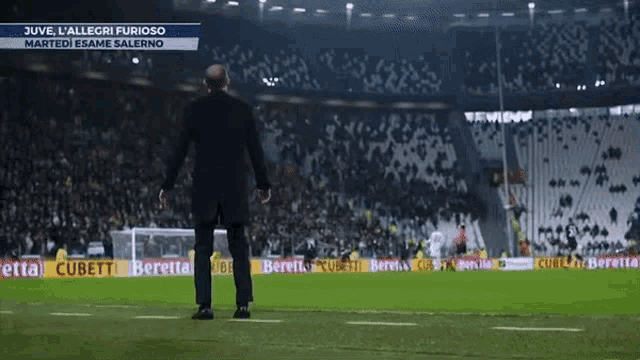 a man stands on a soccer field with the words juve l' allegri furioso on the top