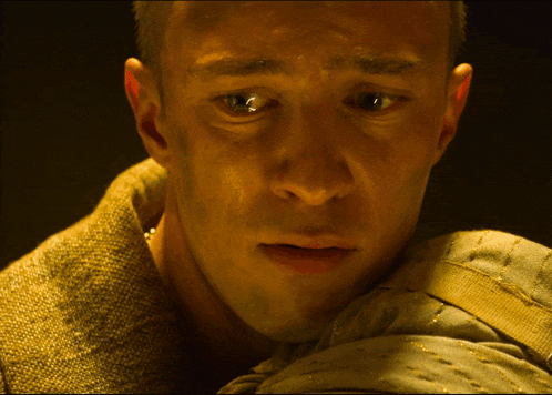 a close up of a man 's face with a tear running down his face