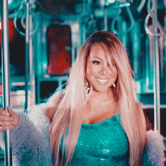 a woman with long blonde hair is wearing a blue top and a fur coat