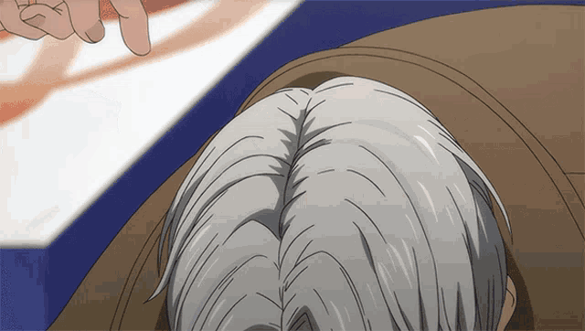 a close up of a person 's hair with a hand pointing to it