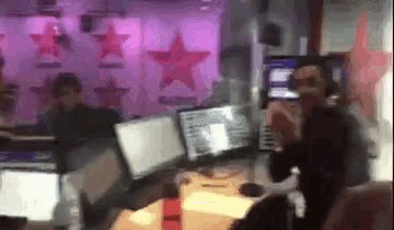 a blurry picture of a person sitting in front of a computer
