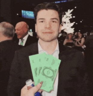 a man in a suit is holding a bottle and a stack of money