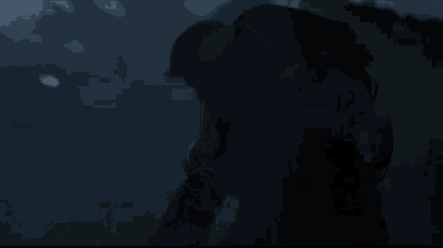 a silhouette of a person in a dark room