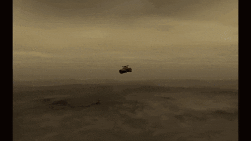 a car is flying in the air over a desert landscape