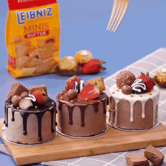 a bag of leibniz minis butter sits behind three cakes