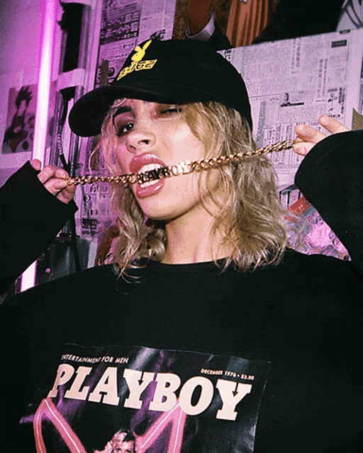 a woman wearing a hat and a playboy sweatshirt