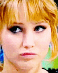 a close up of a woman 's face with a serious expression