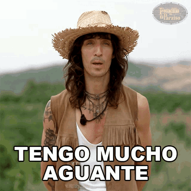 a man with long hair wearing a straw hat and a vest says tengo mucho aguante