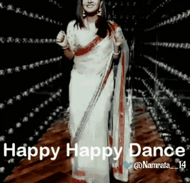 a woman in a white and red saree is dancing with the words happy happy dance behind her