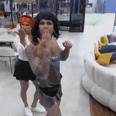 a man and a woman are dancing in a room .
