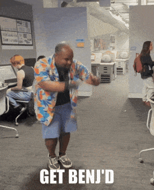 a man in a hawaiian shirt is dancing in an office with the words get benj 'd above him