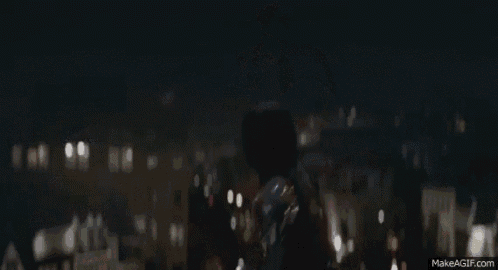 captain america is wearing a mask and holding a shield .