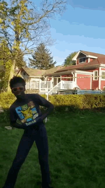 a man wearing sunglasses and a t-shirt that says ' spongebob squarepants ' on it