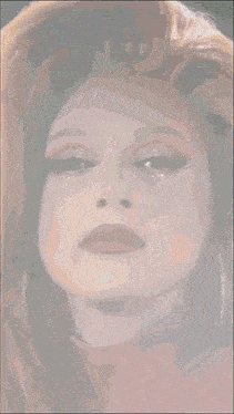 a close up of a woman 's face with red and gold makeup