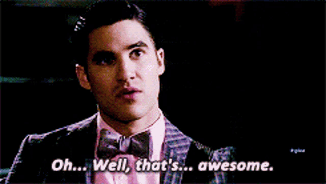 a man in a suit and bow tie is saying " oh well that 's awesome "