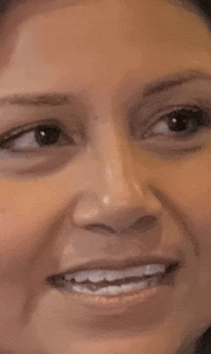 a close up of a woman 's face with a smile on it
