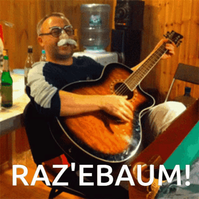a man with a fake mustache is playing an acoustic guitar with the words raz ' ebaum written below him