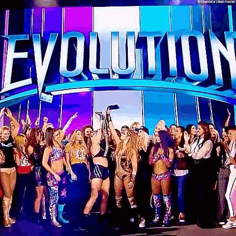 a group of women are standing in front of a large sign that says evolution .