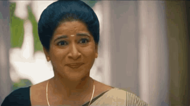 a close up of a woman 's face with a surprised look on her face