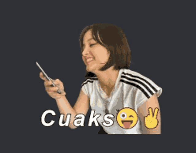 a woman is holding a cell phone with cuaks written on the bottom