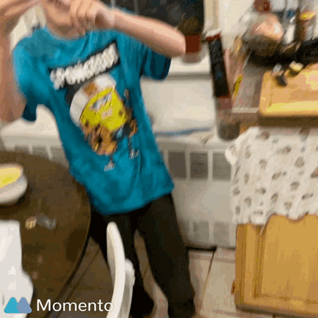 a blurry picture of a person wearing a blue shirt that says spongebob on it