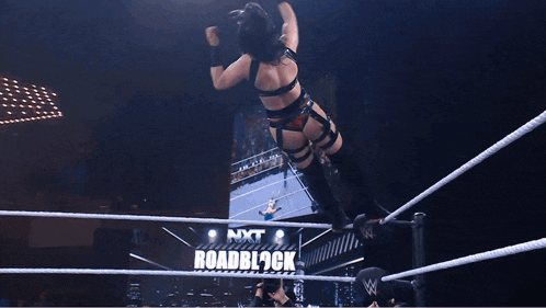 a wrestler in a ring with a sign that says roadblock on it