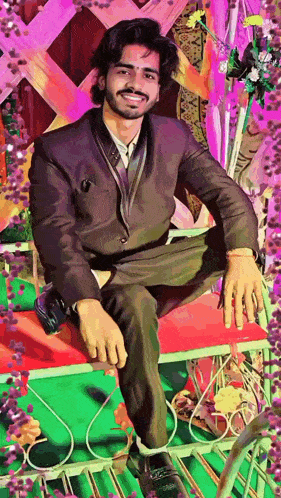 a young man in a suit is sitting on a bench