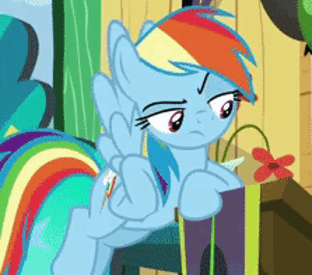 a cartoon pony with a rainbow mane and tail is giving a middle finger
