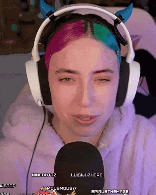a woman wearing headphones with the name ninebuttz on the screen