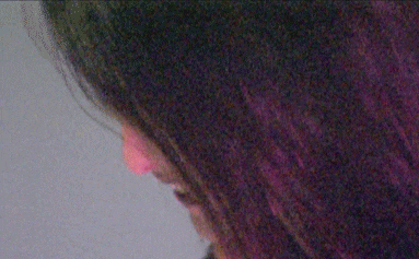 a close up of a woman 's face with her eyes closed smiling .