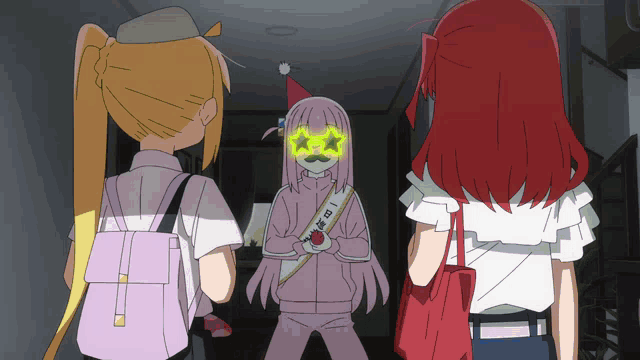 a girl with a mustache is standing in a dark hallway with two other girls