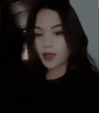 a close up of a woman 's face with a blurred background