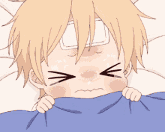 a baby with a bandage on his forehead is laying in bed with a blue blanket .