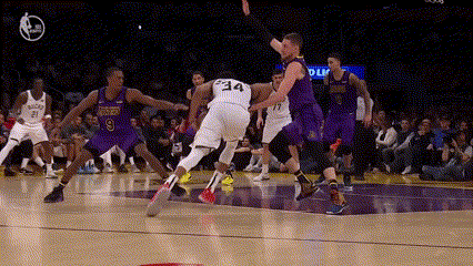 a group of basketball players are playing a game and one player has the number 34 on his jersey