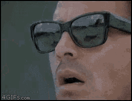 a close up of a man wearing sunglasses with a 4gifs.com watermark