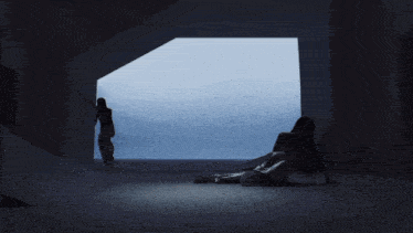 a woman is laying on the floor in front of a blue wall