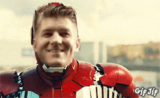 a man in a red iron man suit is smiling with gif jif written on the bottom