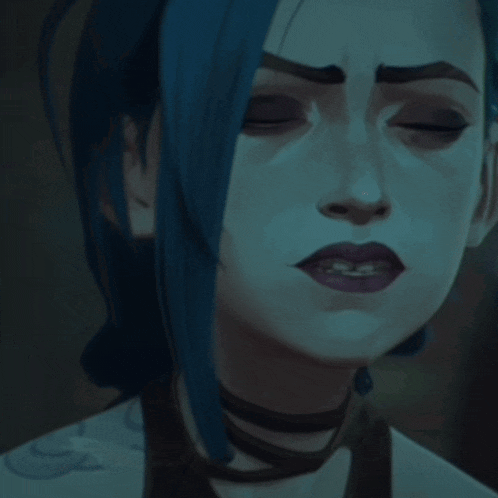 a close up of a woman 's face with blue hair
