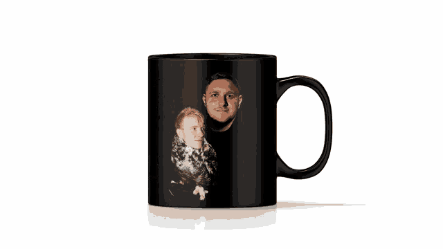 a black coffee mug with a man and woman on it